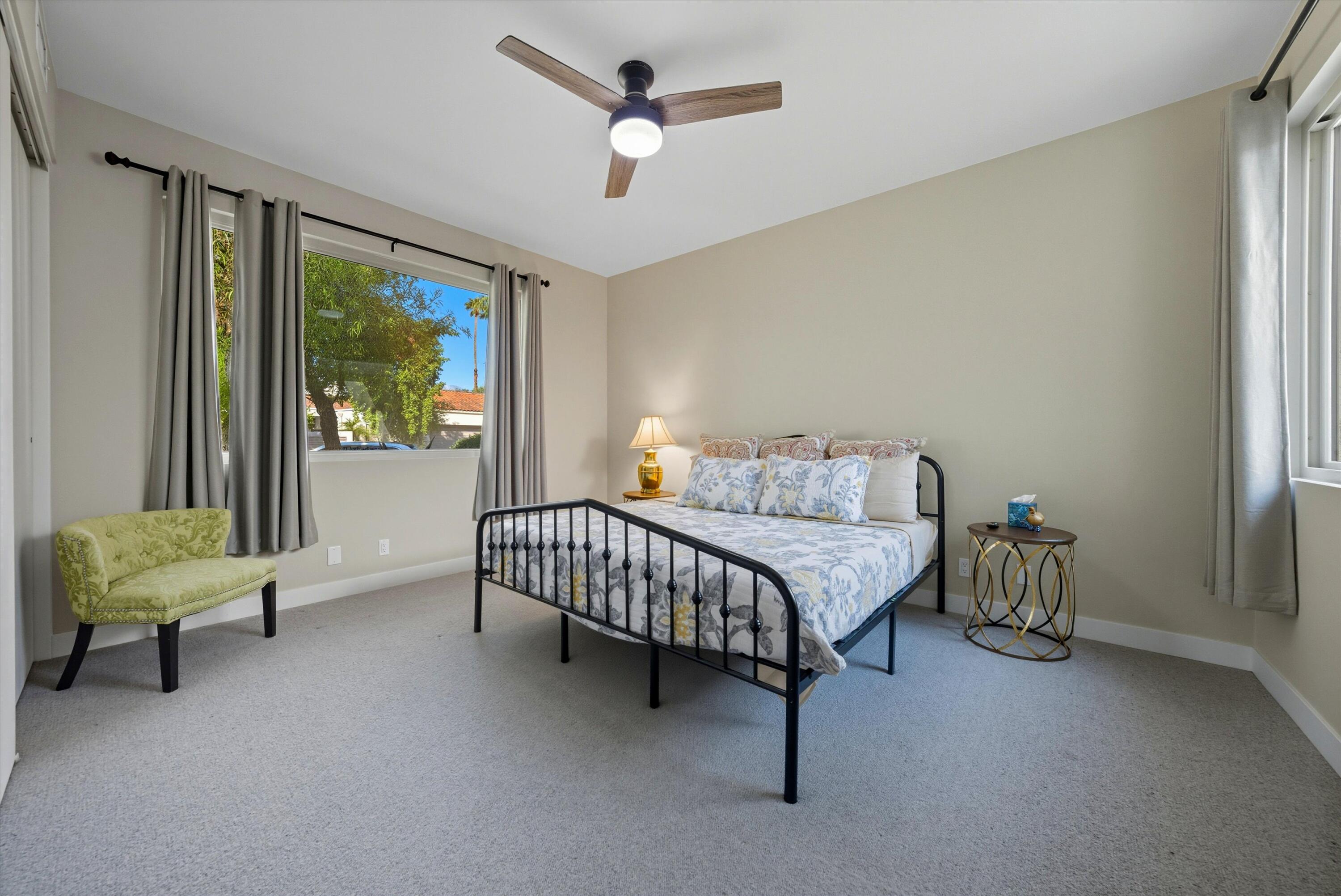 809 Inverness Drive Rancho Mirage, CA 92270 - Photo 29 of 36 a bedroom with a bed and a chandelier