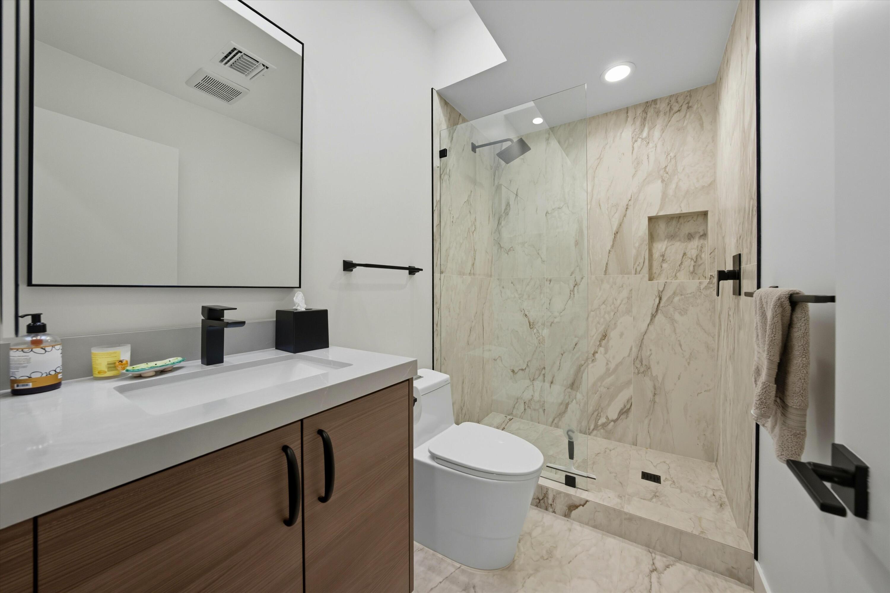 809 Inverness Drive Rancho Mirage, CA 92270 - Photo 30 of 36 a bathroom with a sink a toilet and shower