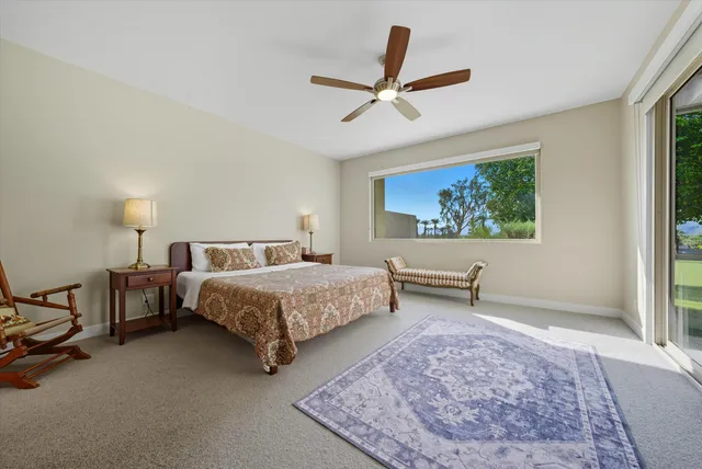 a bedroom with a bed a dresser and a window