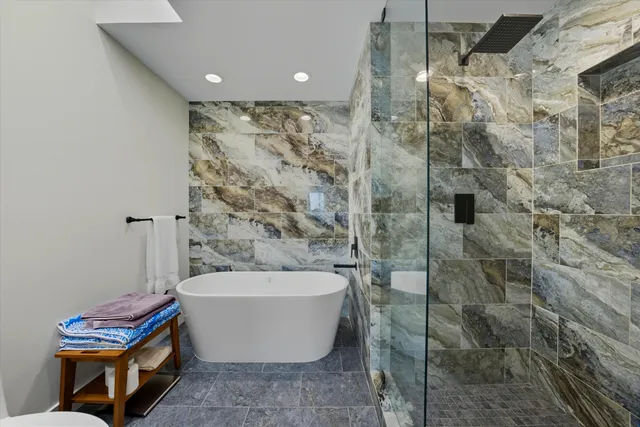 a bathroom with a bathtub and shower