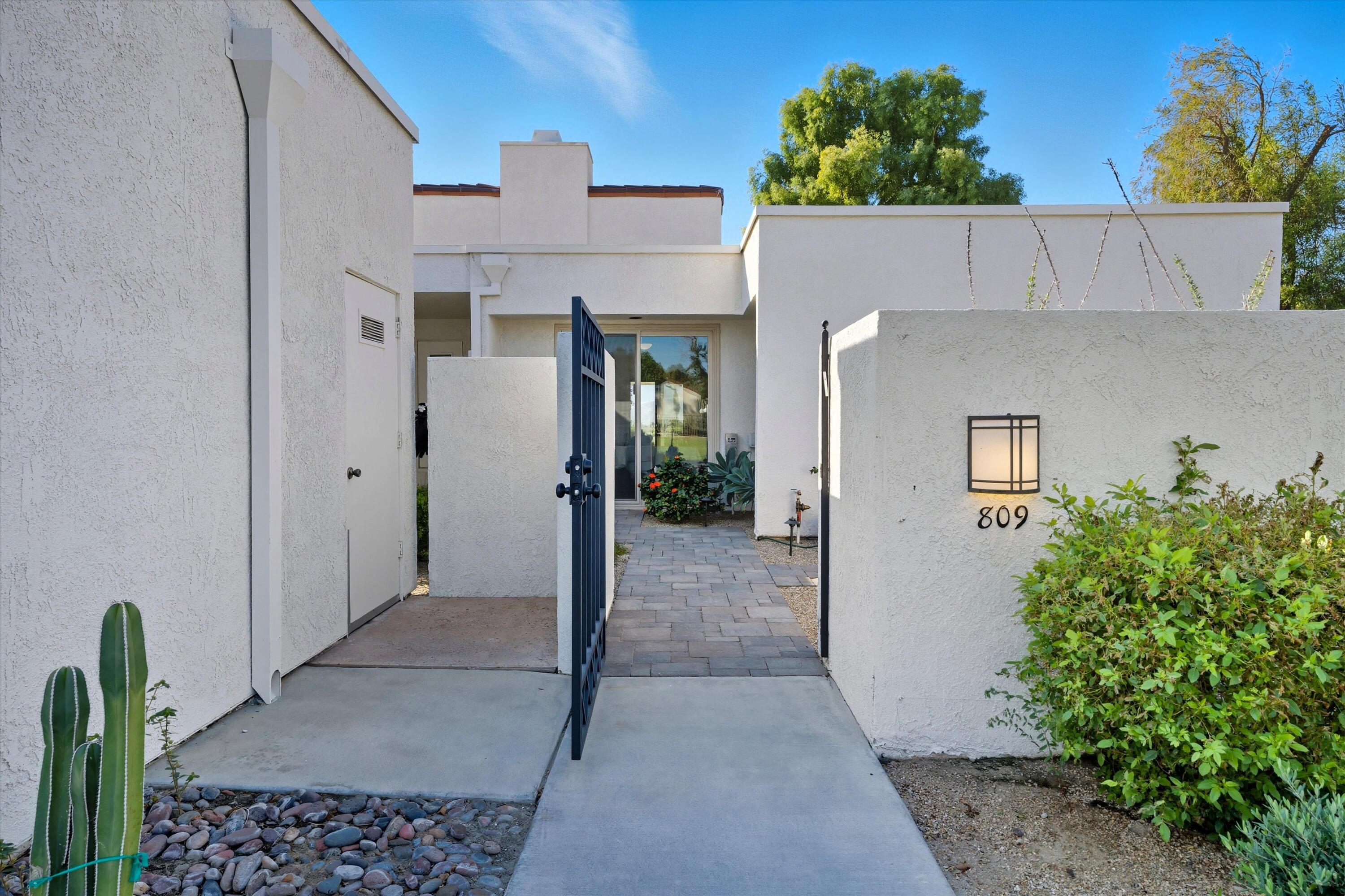 809 Inverness Drive Rancho Mirage, CA 92270 - Photo 7 of 36 front view of a house with a small yard