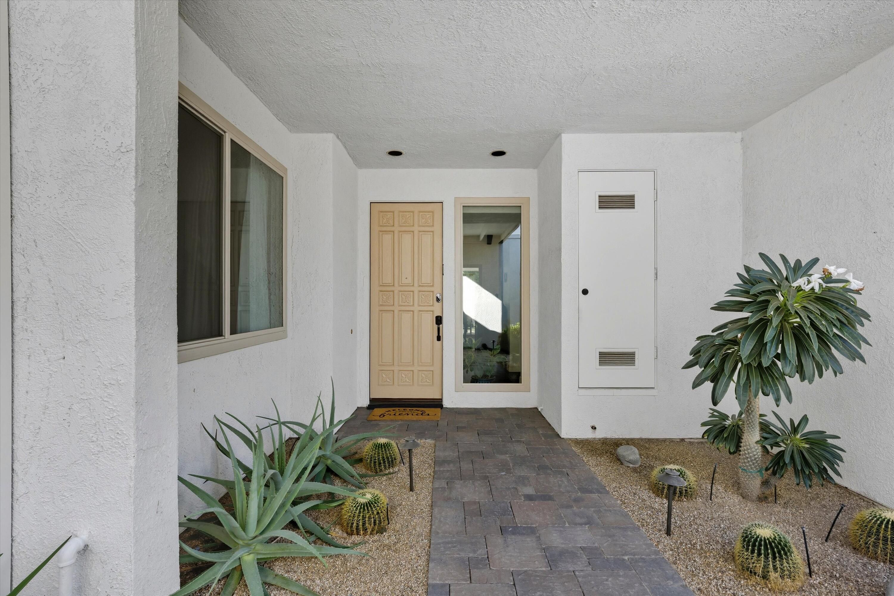 809 Inverness Drive Rancho Mirage, CA 92270 - Photo 9 of 36 a view of a entryway door with potted plants