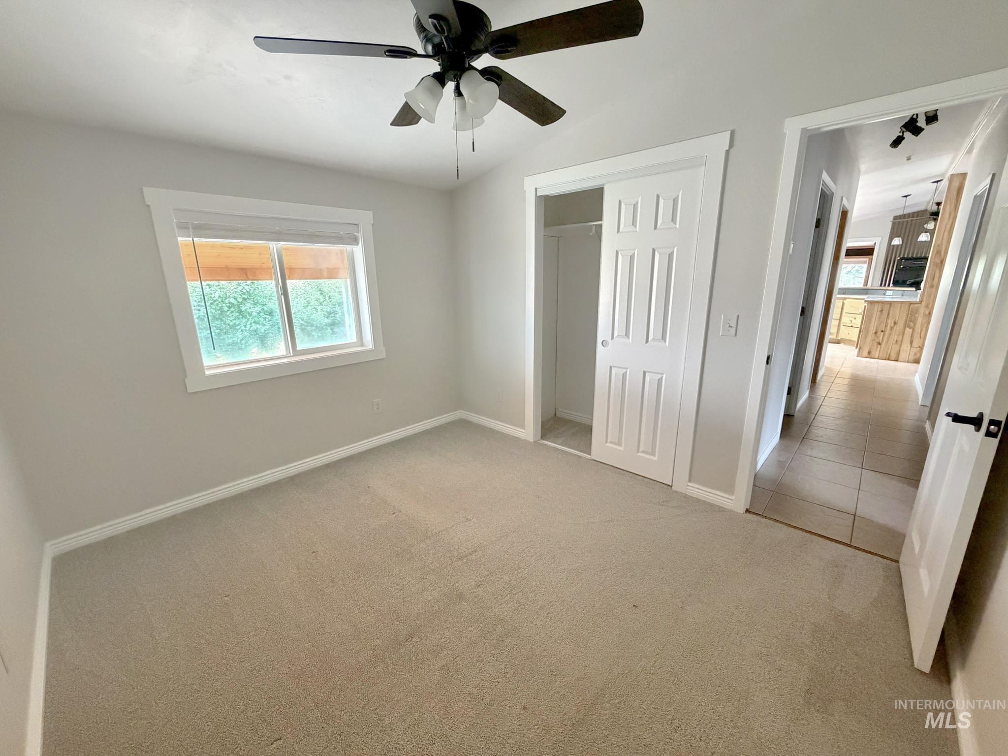 2469 Hague Road Midvale, ID 83645 - Photo 22 of 50 Neutral-toned room with plush carpeting and a modern ceiling fan