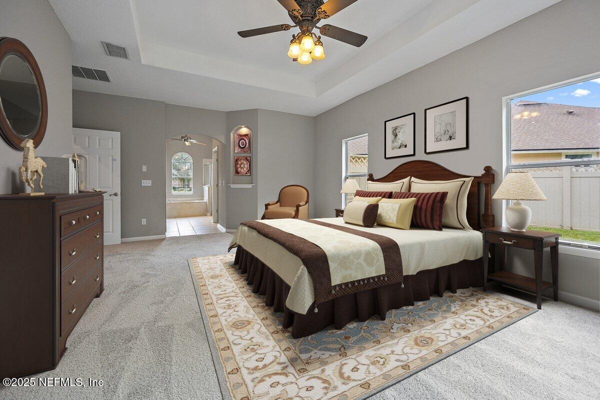 2045 River's Own Road St. Augustine, FL 32092 - Photo 11 of 43 a bedroom with a bed and a chandelier