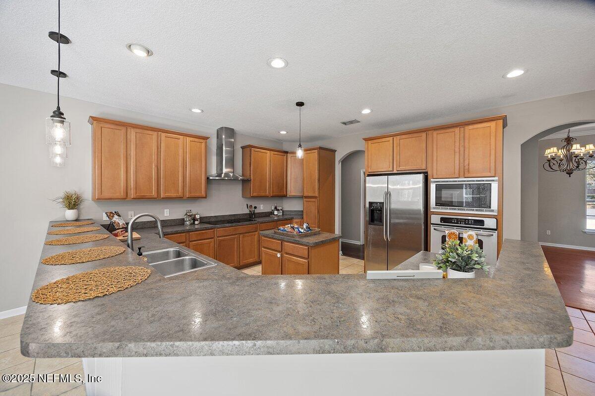 2045 River's Own Road St. Augustine, FL 32092 - Photo 16 of 43 a kitchen with stainless steel appliances granite countertop a sink and a refrigerator