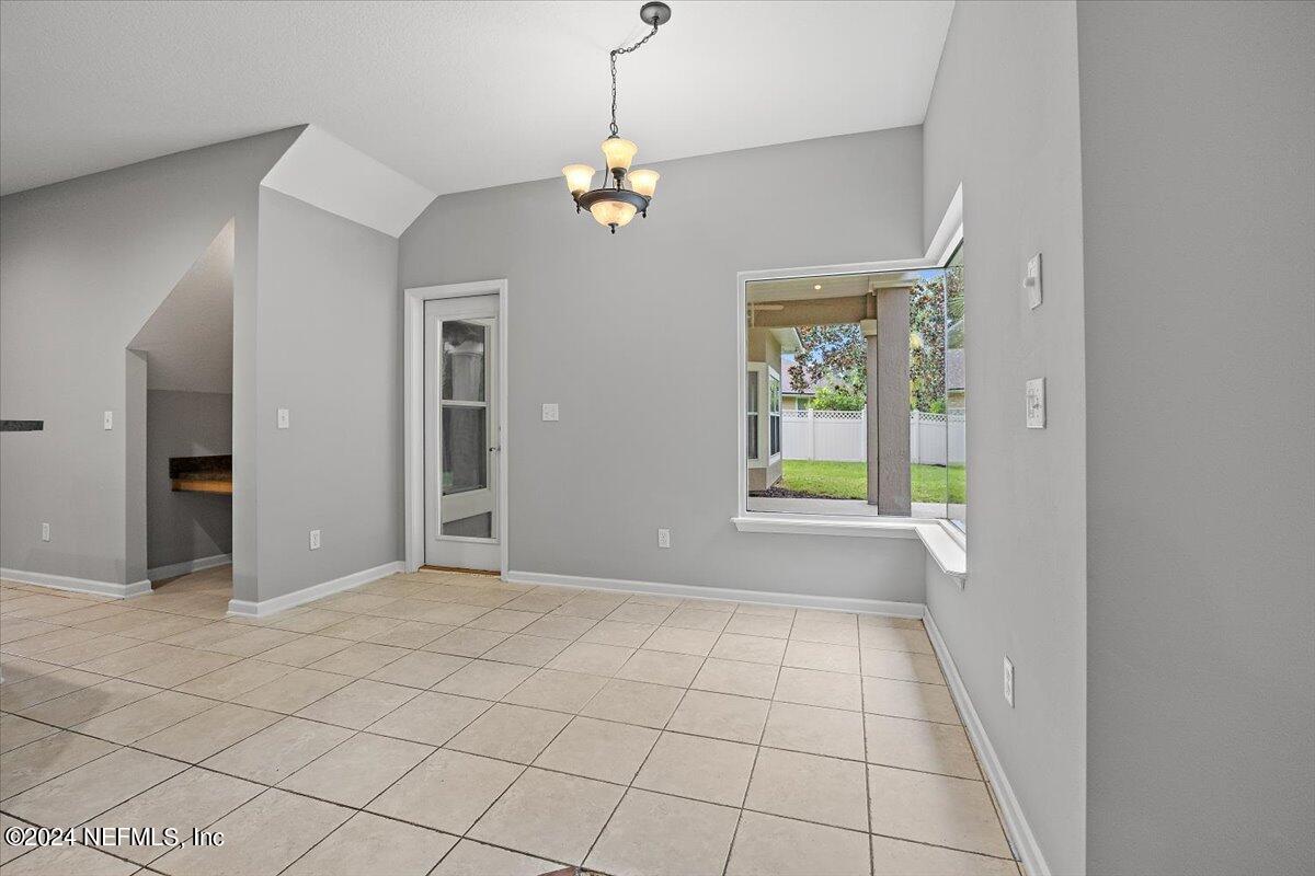 2045 River's Own Road St. Augustine, FL 32092 - Photo 19 of 43 a view of an empty room with window and chandelier fan