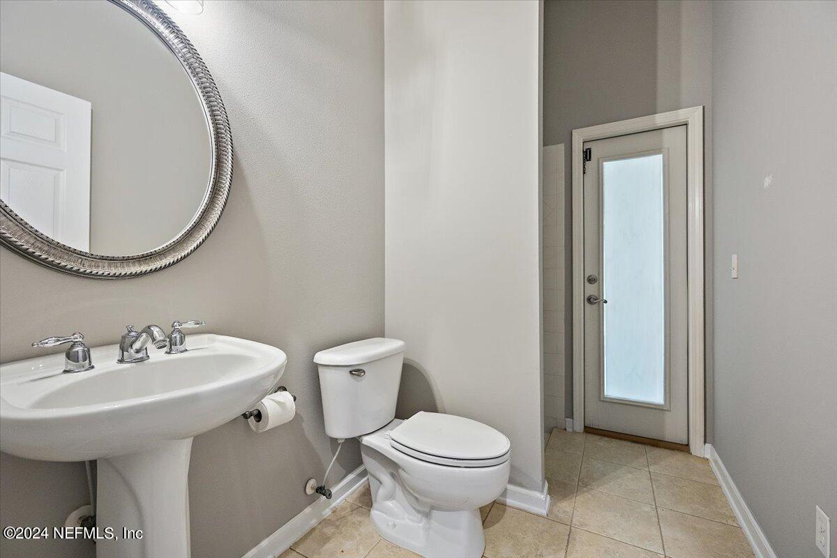 2045 River's Own Road St. Augustine, FL 32092 - Photo 24 of 43 a bathroom with a sink a toilet and a mirror