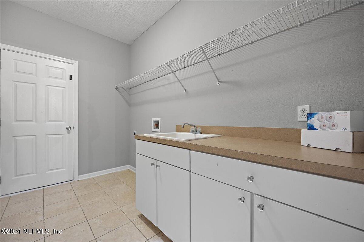 2045 River's Own Road St. Augustine, FL 32092 - Photo 28 of 43 a bathroom with a sink and cabinets