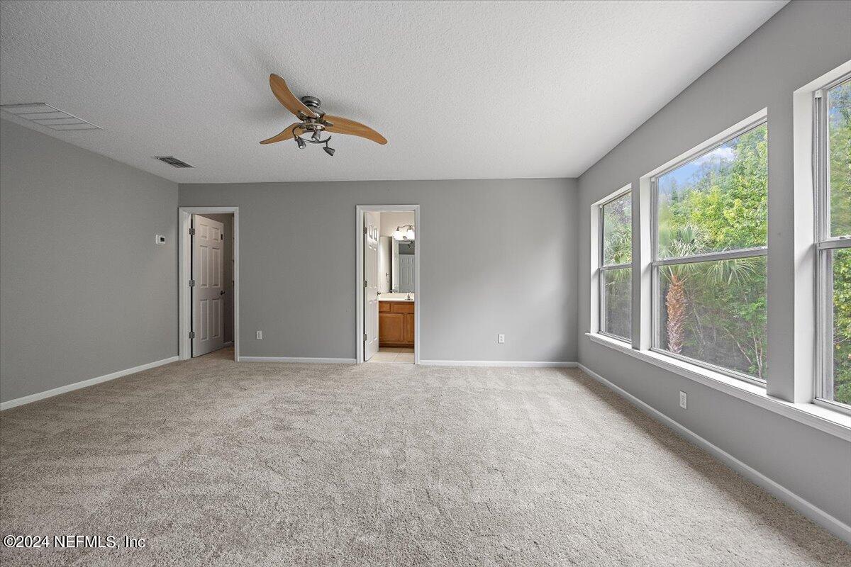 2045 River's Own Road St. Augustine, FL 32092 - Photo 29 of 43 an empty room with windows and ceiling fan view