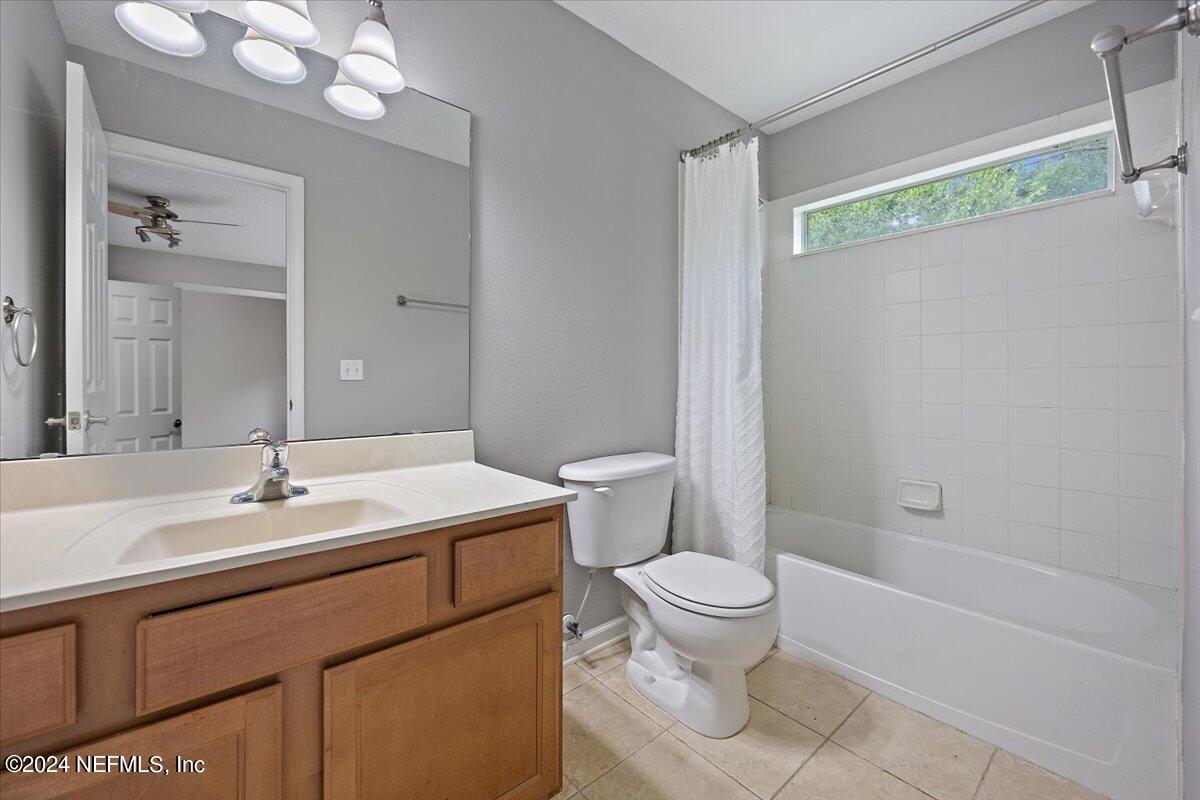 2045 River's Own Road St. Augustine, FL 32092 - Photo 30 of 43 a bathroom with a sink a toilet a mirror and shower