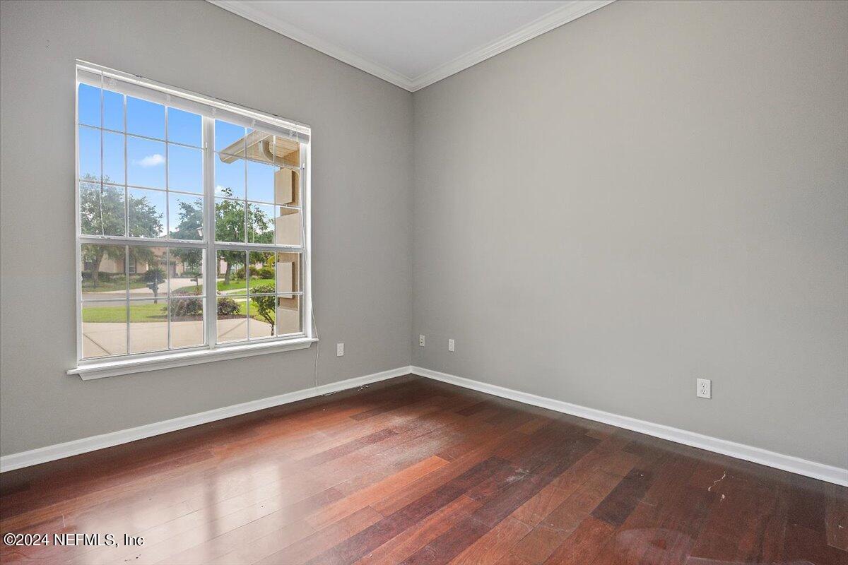 2045 River's Own Road St. Augustine, FL 32092 - Photo 5 of 43 an empty room with wooden floor and windows