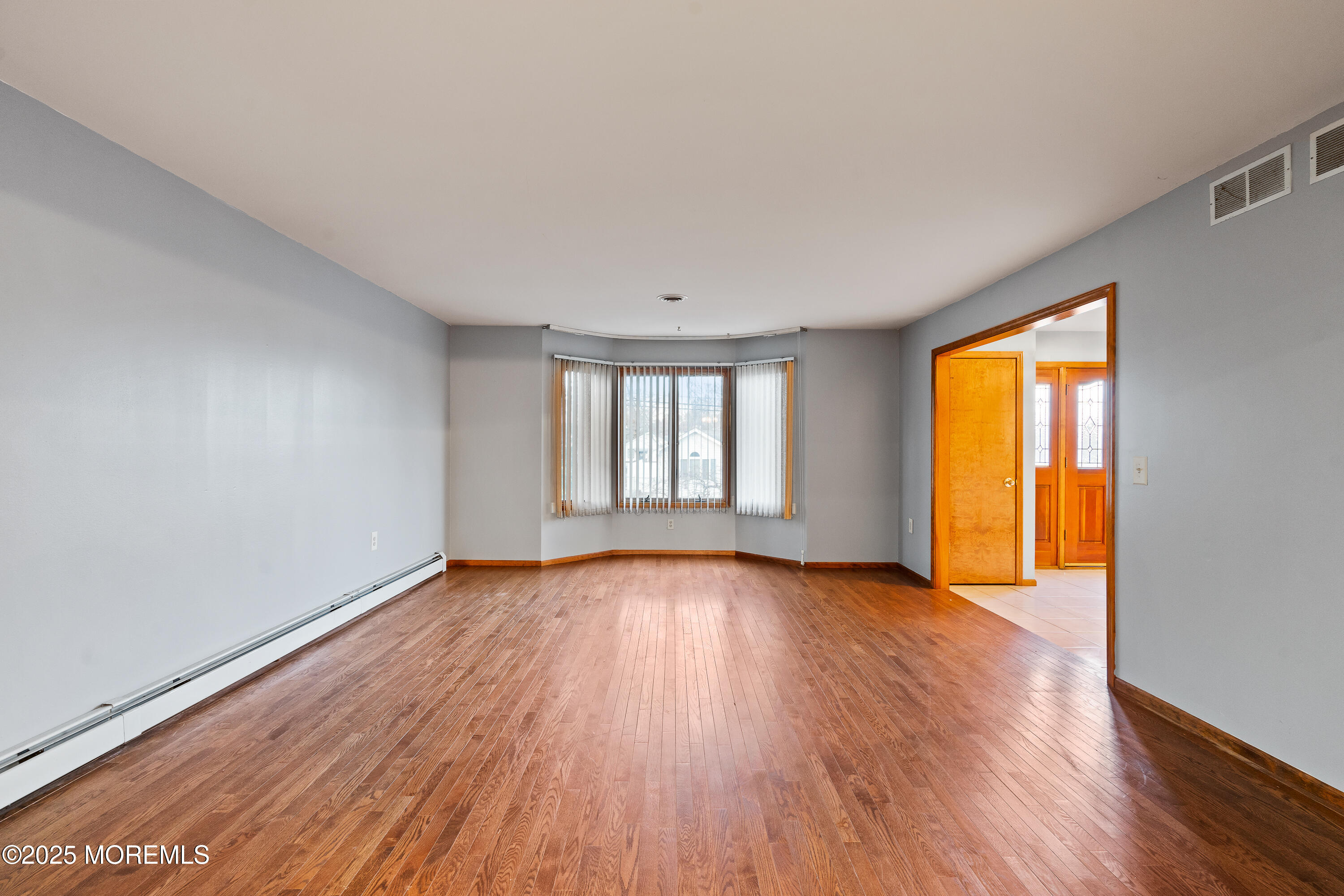 2003 Teakwood Road Toms River, NJ 08753 - Photo 12 of 47 a view of an empty room with wooden floor and a window