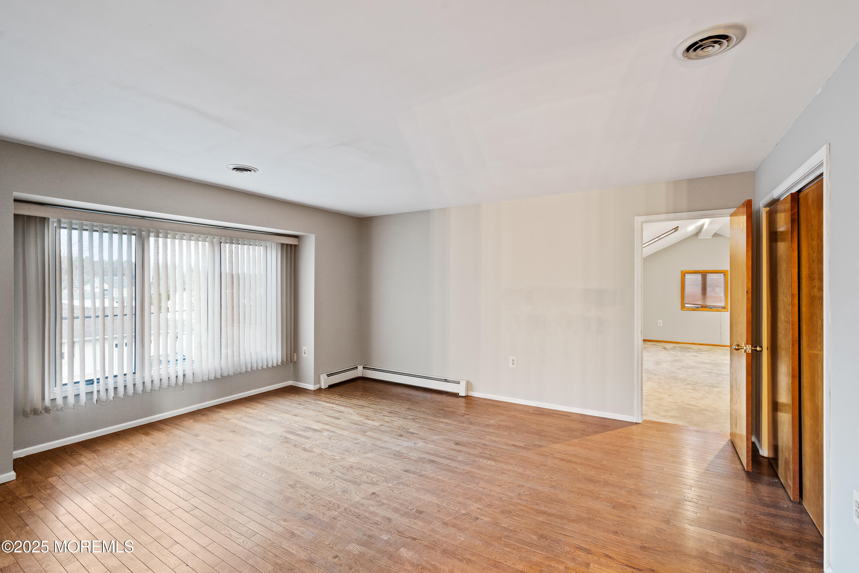 2003 Teakwood Road Toms River, NJ 08753 - Photo 24 of 47 a view of an empty room with wooden floor and a window