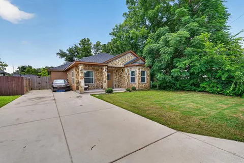 a view of house with yard and green space