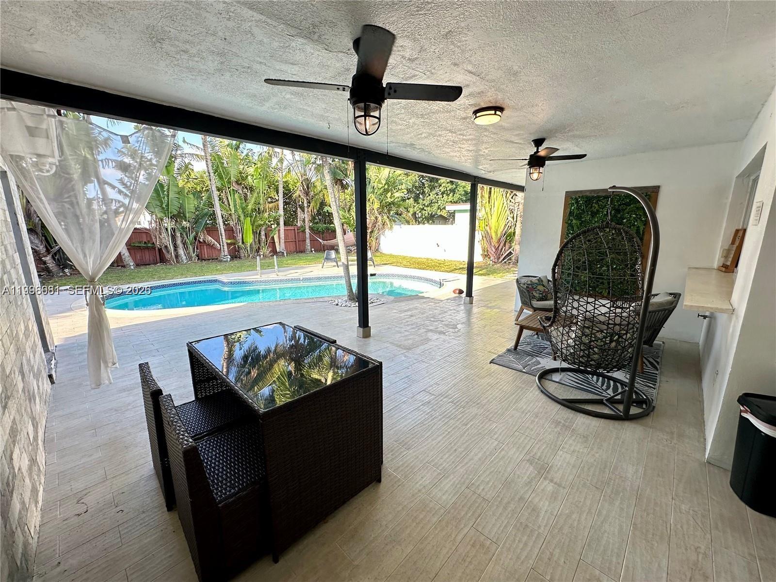 5424 Garfield Street Hollywood, FL 33021 - Photo 16 of 59 a living room with furniture and a large window