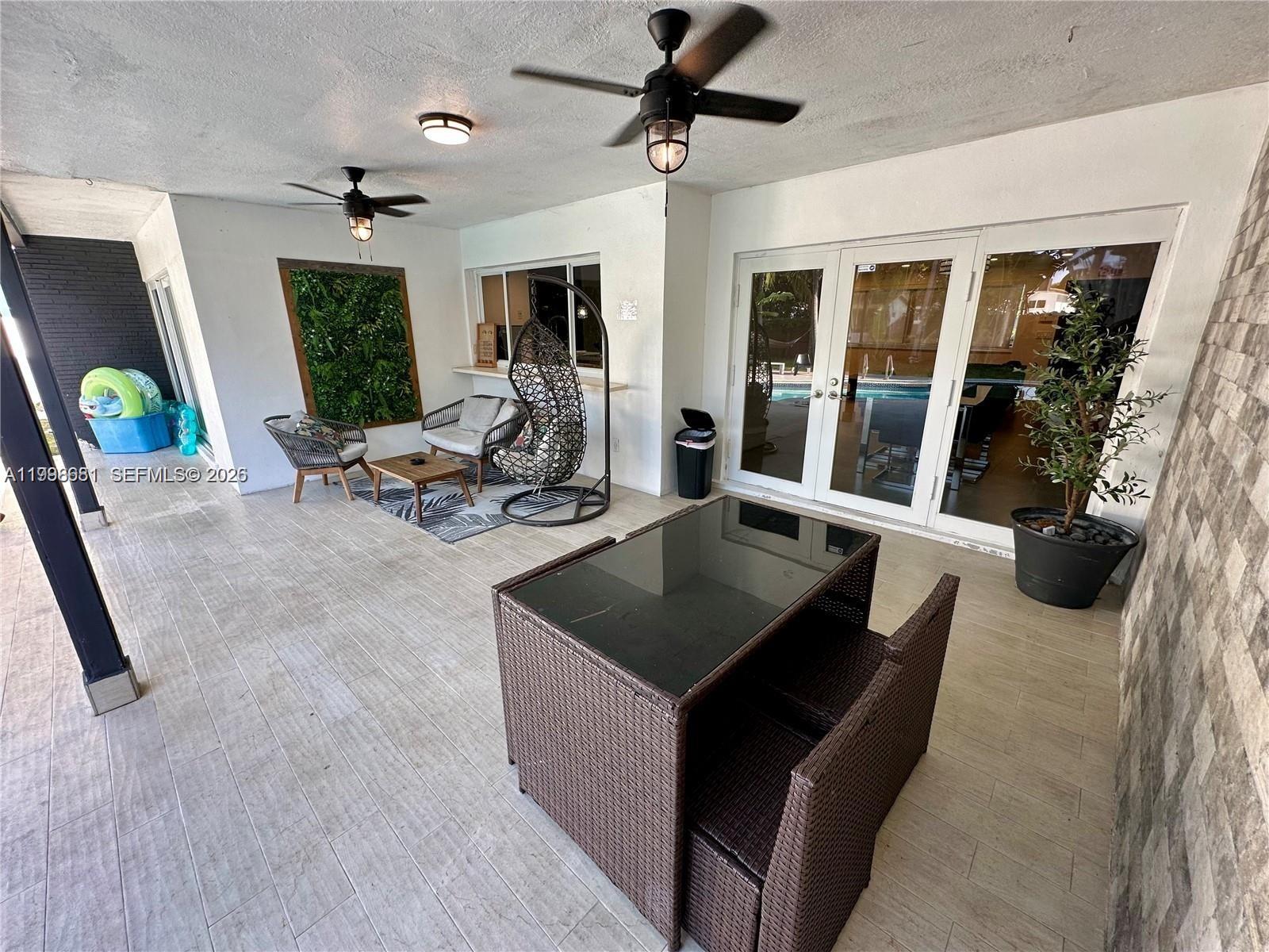 5424 Garfield Street Hollywood, FL 33021 - Photo 17 of 59 a living room with furniture and a table