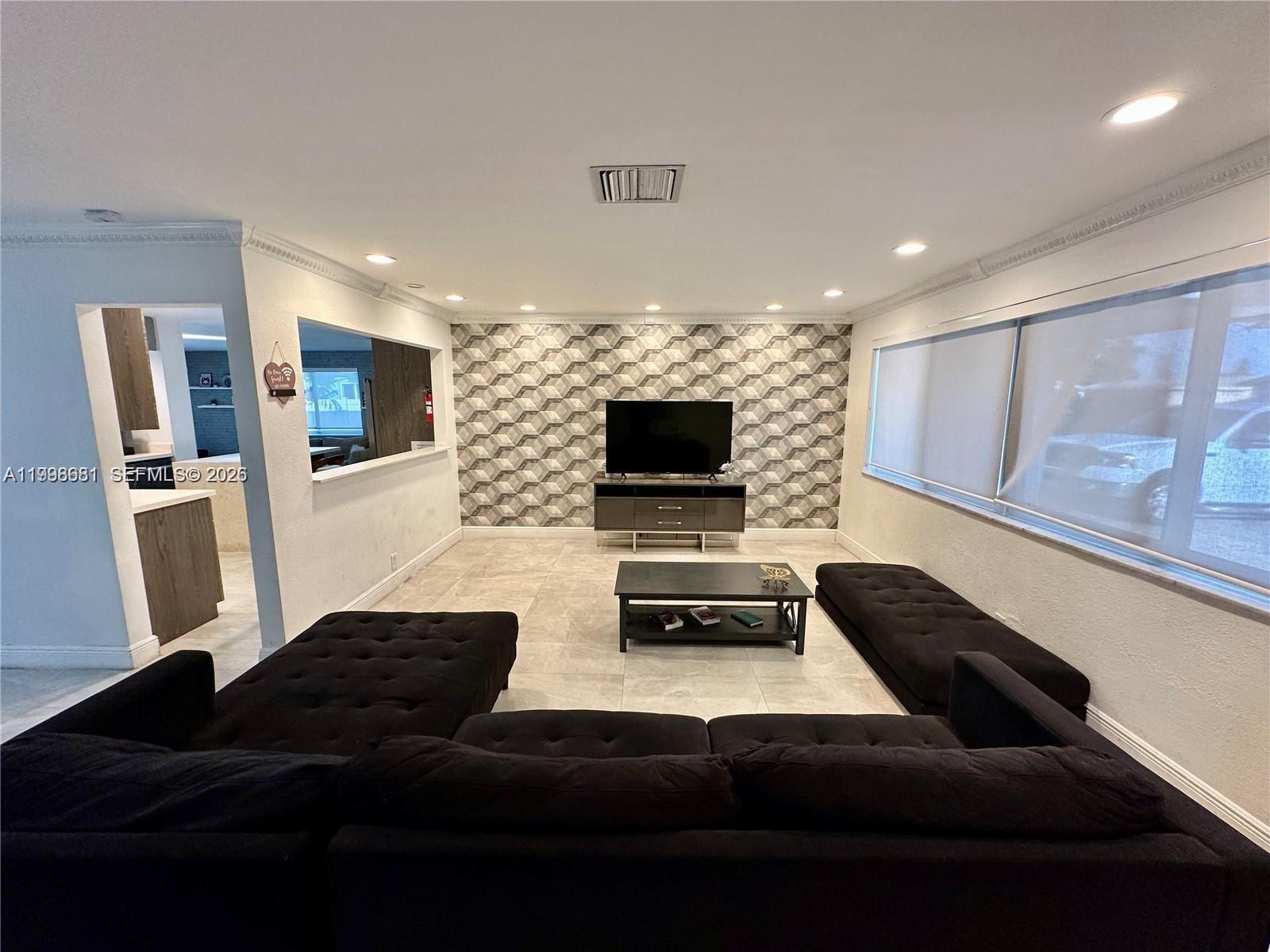 5424 Garfield Street Hollywood, FL 33021 - Photo 21 of 59 a living room with furniture and a flat screen tv