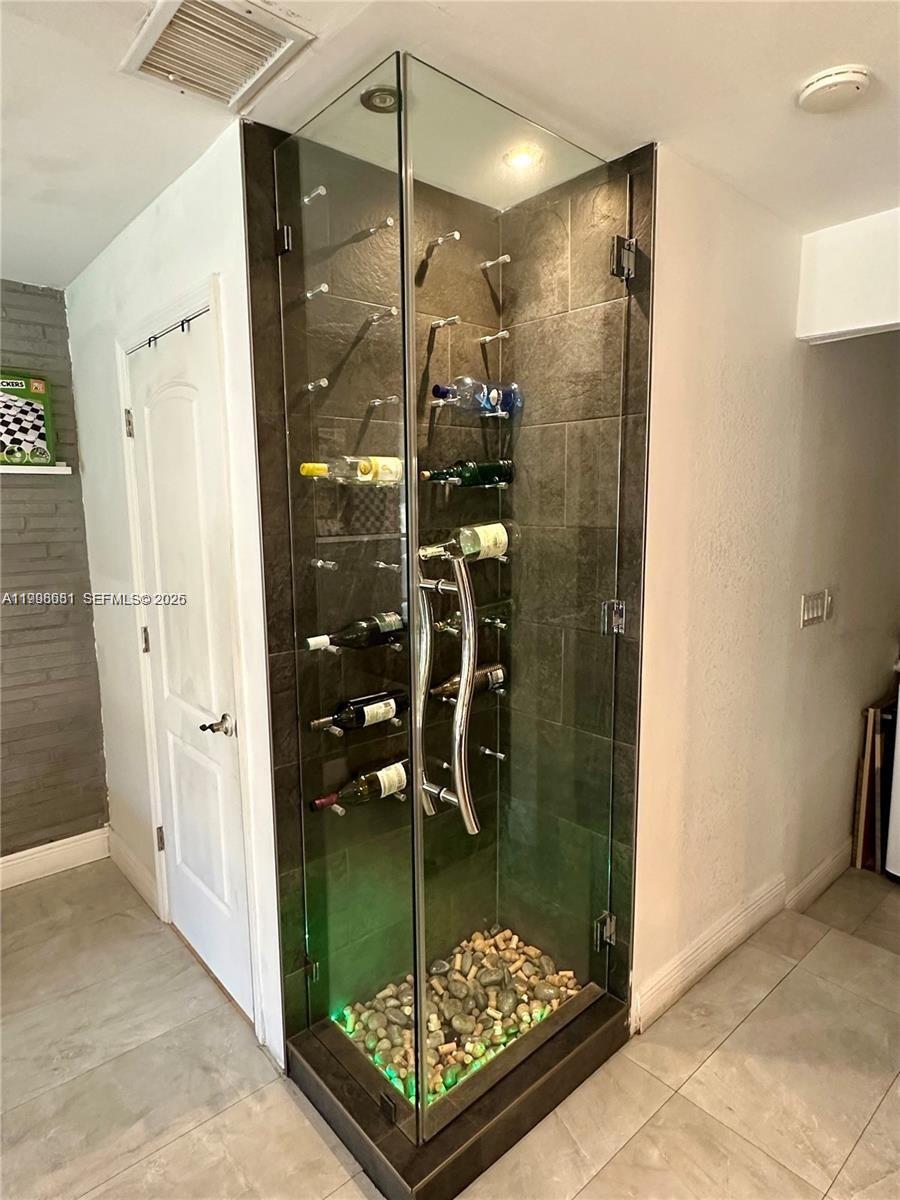 5424 Garfield Street Hollywood, FL 33021 - Photo 30 of 59 a bathroom with a glass shower door and a sink