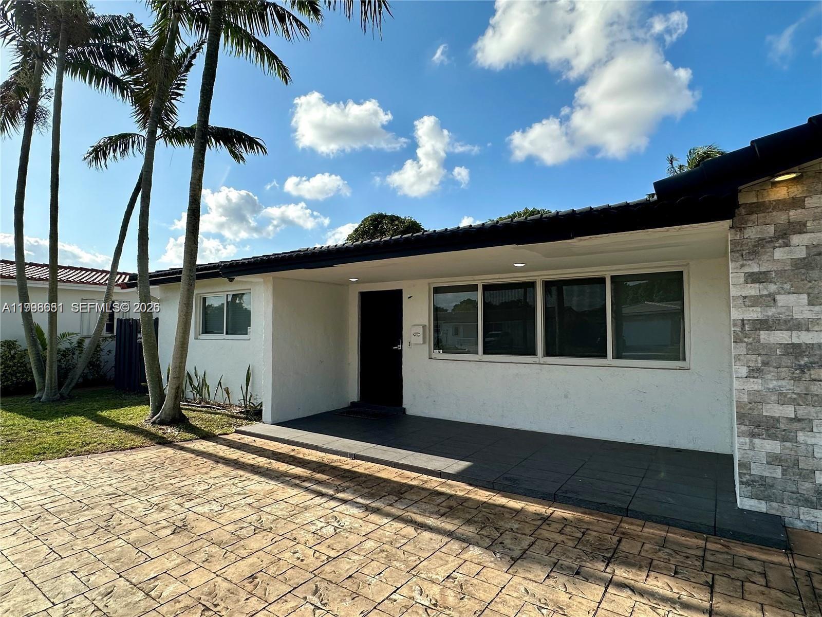 5424 Garfield Street Hollywood, FL 33021 - Photo 3 of 59 a front view of a house with a yard