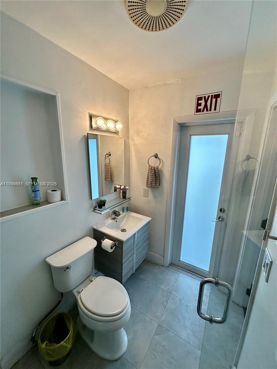 5424 Garfield Street Hollywood, FL 33021 - Photo 45 of 59 a bathroom with a toilet sink and shower