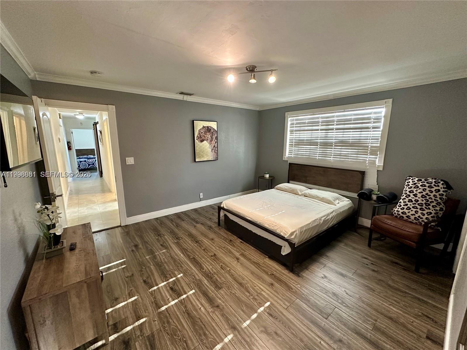 5424 Garfield Street Hollywood, FL 33021 - Photo 46 of 59 a bedroom with a bed window and a couch