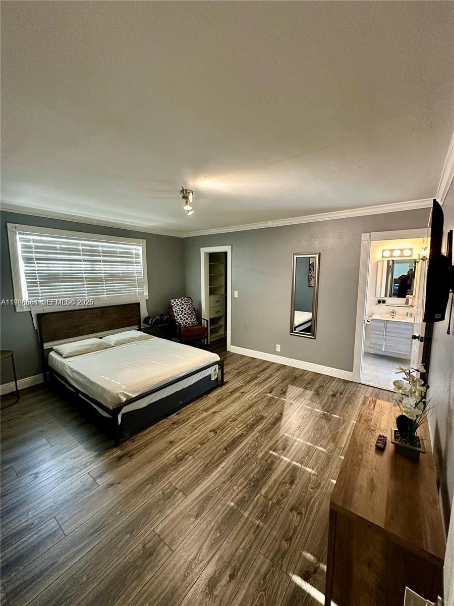 5424 Garfield Street Hollywood, FL 33021 - Photo 48 of 59 a bedroom with a bed and a night stand
