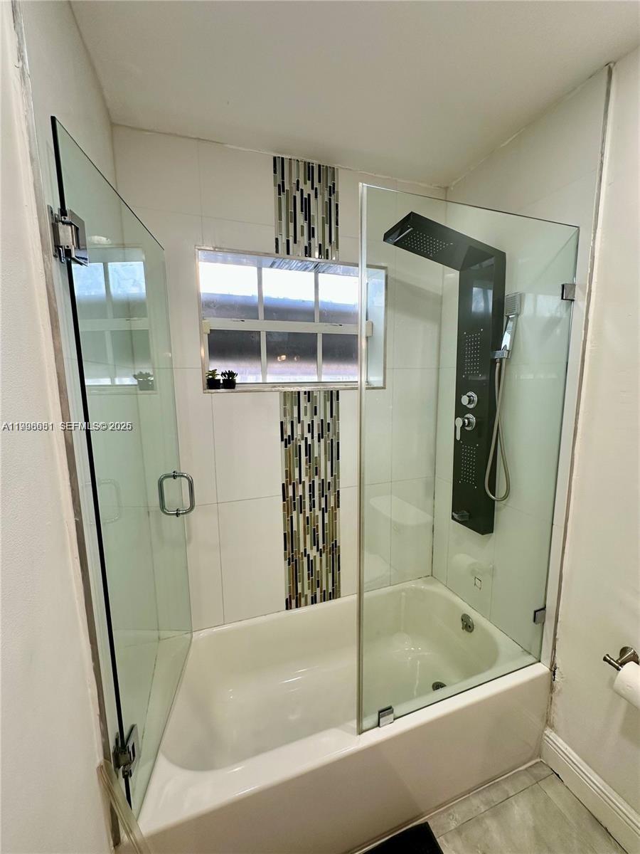 5424 Garfield Street Hollywood, FL 33021 - Photo 50 of 59 a bathroom with bathtub and shower