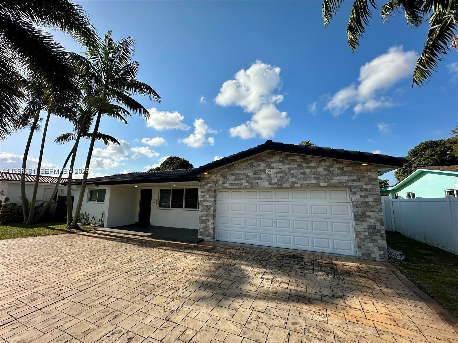 5424 Garfield Street Hollywood, FL 33021 - Photo 5 of 59 a front view of a house with a yard
