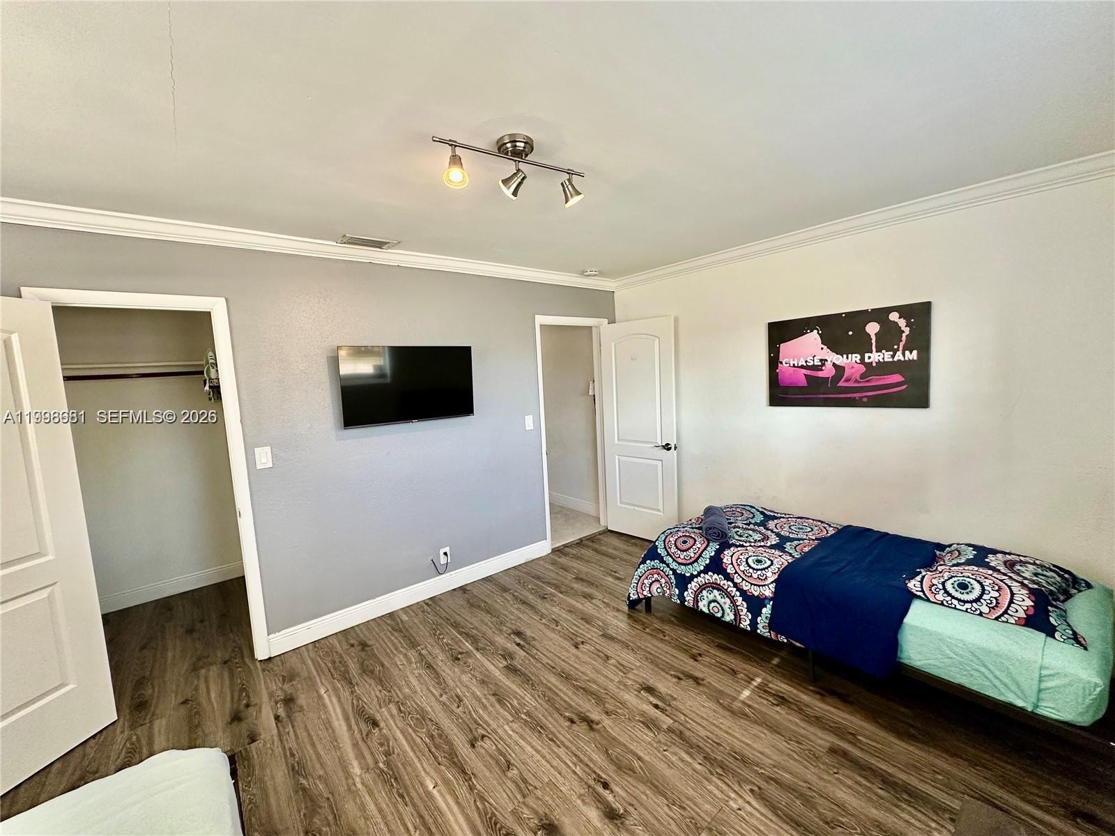 5424 Garfield Street Hollywood, FL 33021 - Photo 56 of 59 a living room with furniture and a flat screen tv