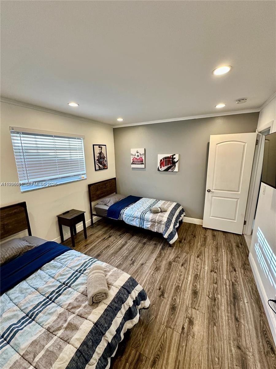 5424 Garfield Street Hollywood, FL 33021 - Photo 58 of 59 a bedroom with a bed and wooden floor