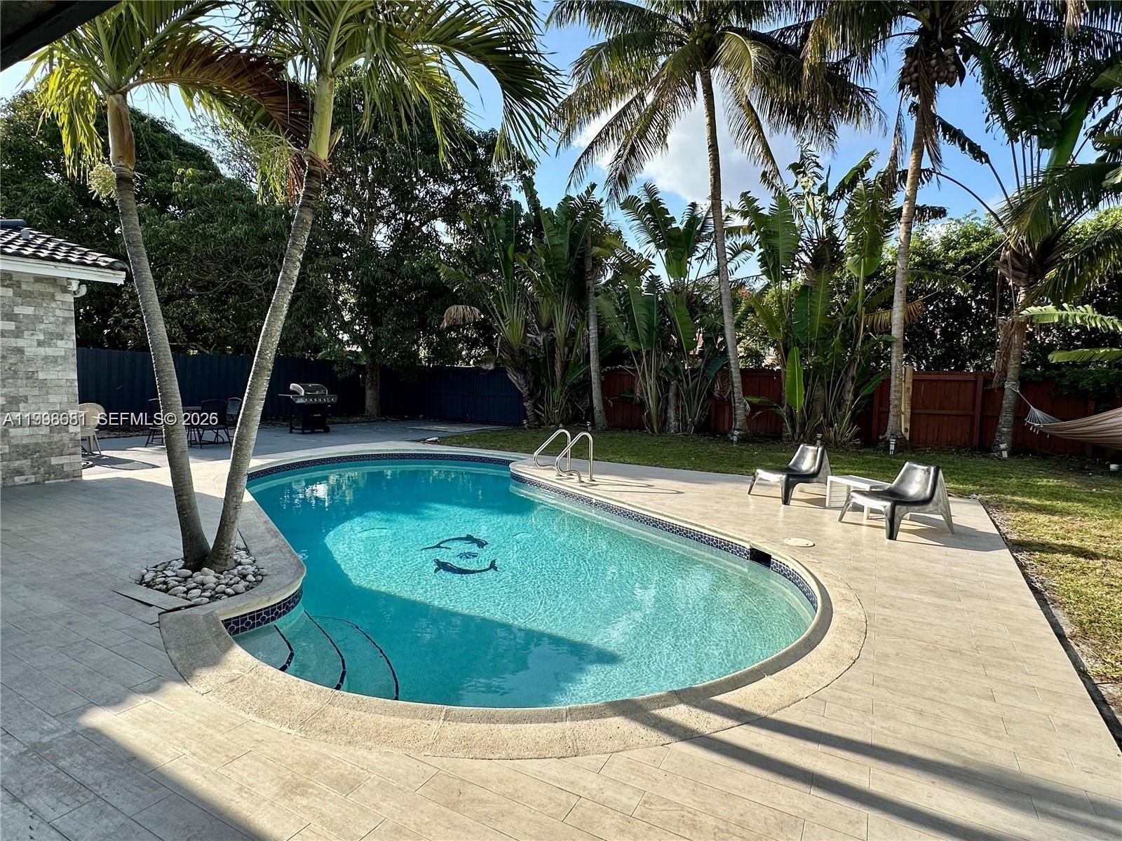 5424 Garfield Street Hollywood, FL 33021 - Photo 7 of 59 a view of a swimming pool with a house