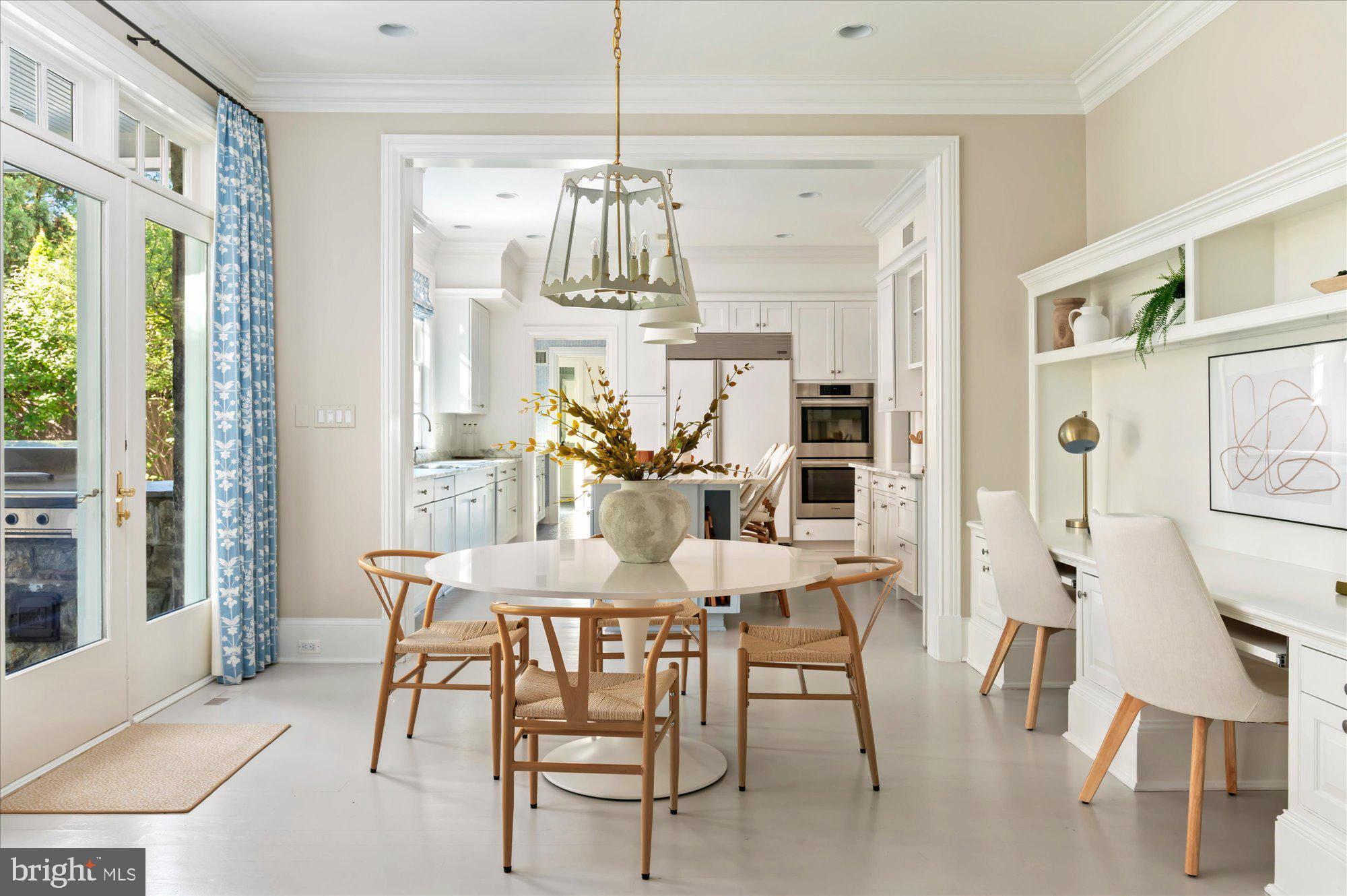 2950 Chain Bridge Road Northwest Washington, DC 20016 - Photo 13 of 50 a view of a dining room with furniture a chandelier and large window
