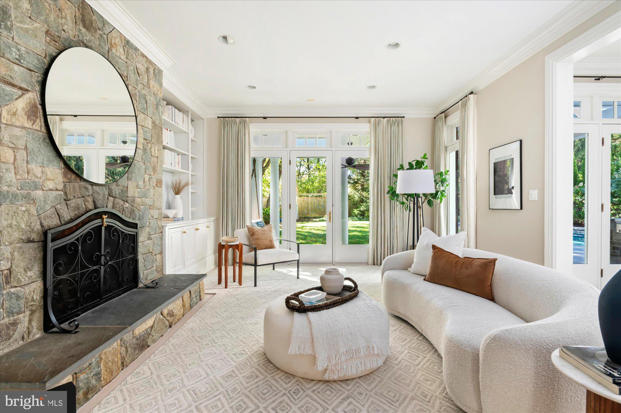 2950 Chain Bridge Road Northwest Washington, DC 20016 - Photo 14 of 50 a living room with furniture a fireplace and a floor to ceiling window