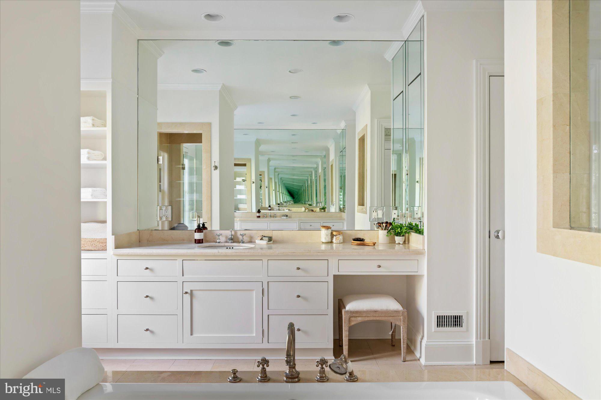 2950 Chain Bridge Road Northwest Washington, DC 20016 - Photo 21 of 50 a view of cabinets with a sink and mirror with bathtub