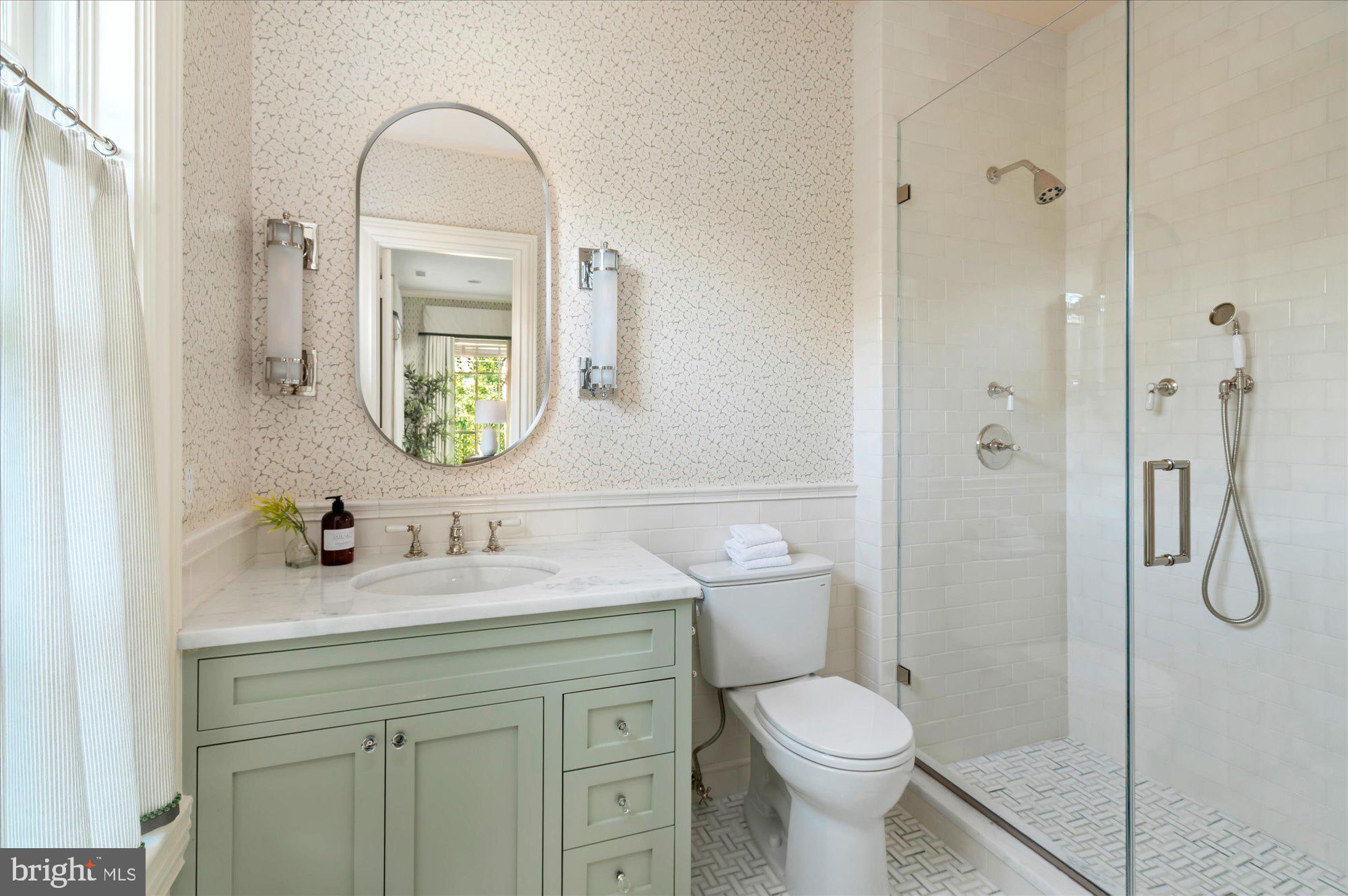 2950 Chain Bridge Road Northwest Washington, DC 20016 - Photo 29 of 50 a bathroom with a toilet sink vanity and shower