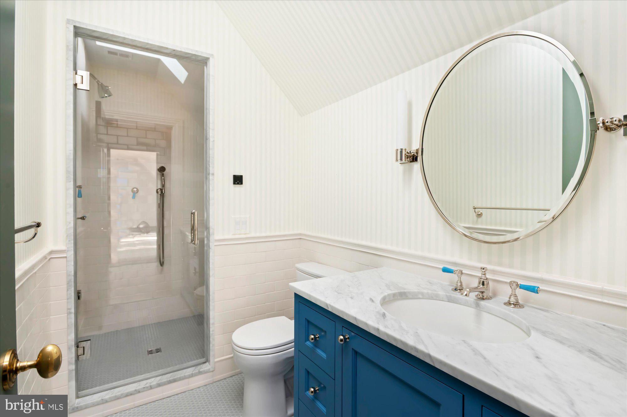 2950 Chain Bridge Road Northwest Washington, DC 20016 - Photo 33 of 50 a bathroom with a granite countertop sink a toilet and shower