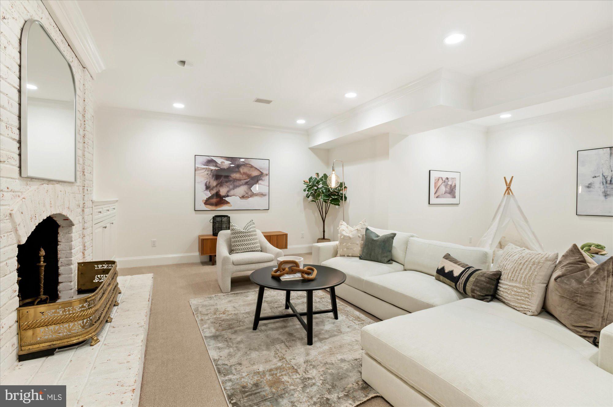 2950 Chain Bridge Road Northwest Washington, DC 20016 - Photo 35 of 50 a living room with furniture a fireplace and a flat screen tv