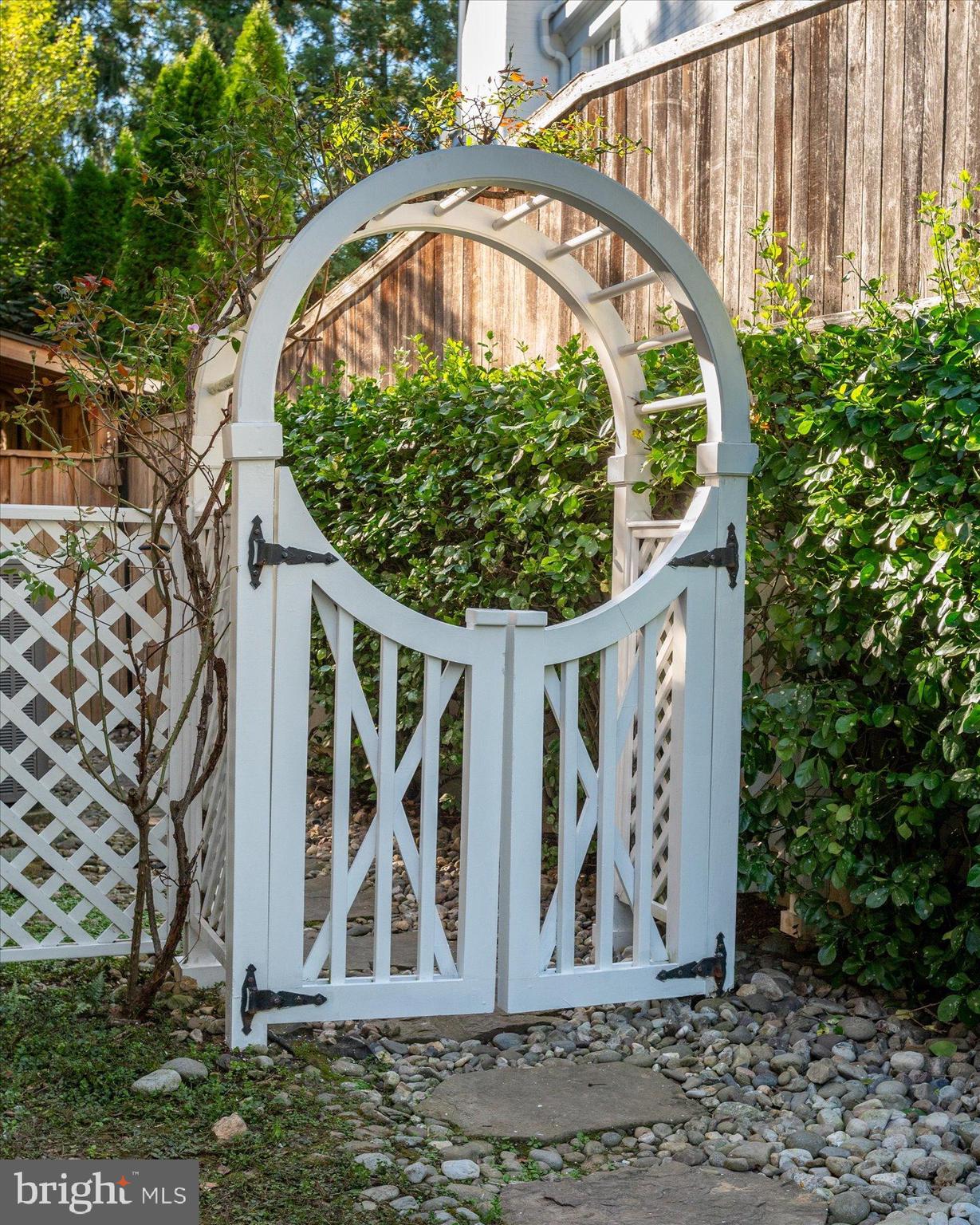 2950 Chain Bridge Road Northwest Washington, DC 20016 - Photo 50 of 50 a view of a brick house with a large windows and plants