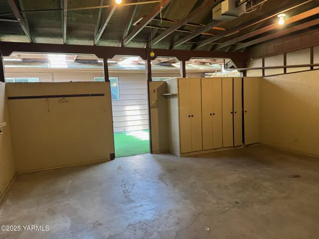 a view of empty room with wooden walls