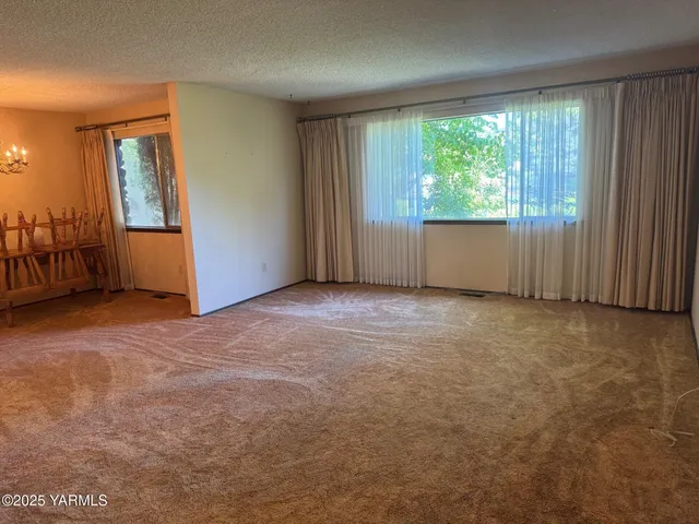 an empty room with large window