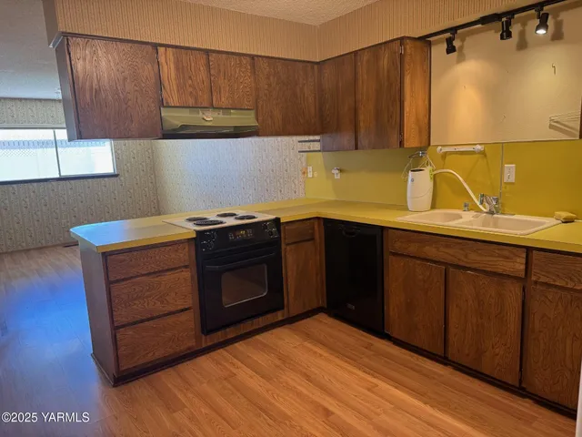 a kitchen with a sink and a stove