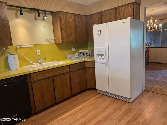 a white refrigerator freezer sitting inside of a kitchen