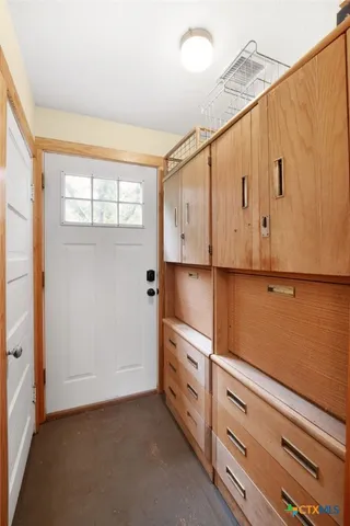 a kitchen with white cabinets and white appliances
