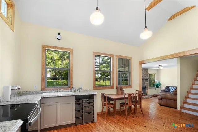 a view of a dining room with furniture and wooden floor