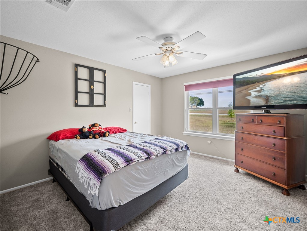 782 Santa Clara Loop Marion, TX 78124 - Photo 46 of 48 a bedroom with a bed and a flat screen tv