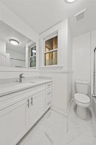 a living room with furniture and large windows