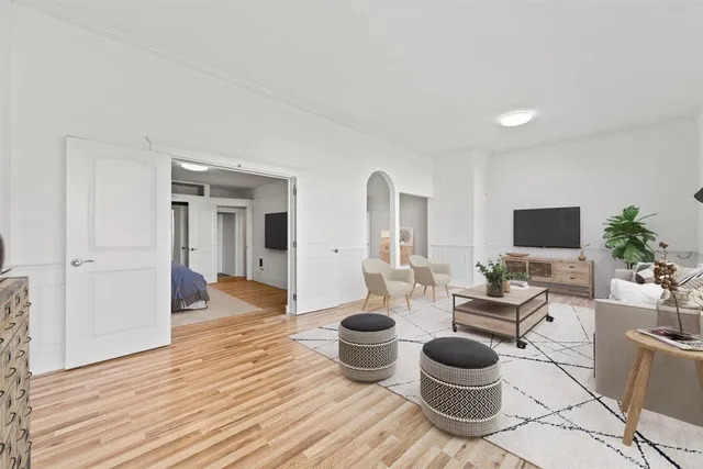 a living room with furniture and wooden floor