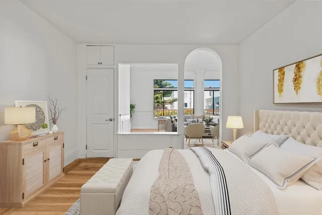 a bedroom with a large bed and a mirror