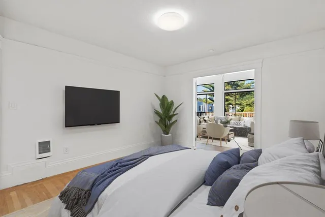 a bedroom with a large bed and a flat screen tv