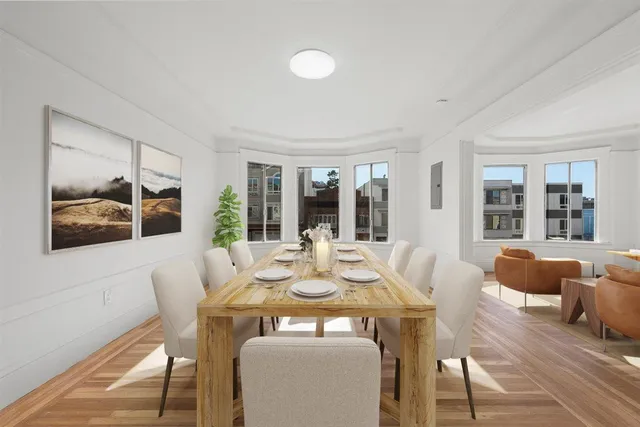 a view of a dining room with furniture window and wooden floor
